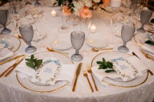 New gold flatware featured at a wedding in New York with candlelit tables and whimsical florals.